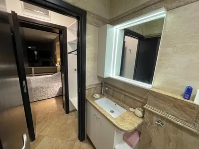 a bathroom with a sink and a mirror at Premium Studio Apartment in Private Villa Nisim in Batak