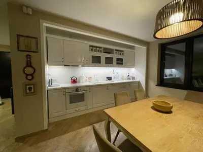 a kitchen with a table and a dining room at Premium Studio Apartment in Private Villa Nisim in Batak