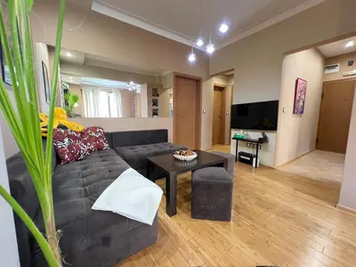 a living room with a couch and a table at Hamburg 100 Sq M 2BDR Family Apt near NDK and Vitosha BLVD in Sofia