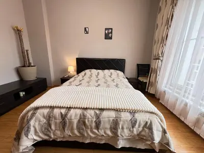 a bedroom with a bed and a large window at Hamburg 100 Sq M 2BDR Family Apt near NDK and Vitosha BLVD in Sofia