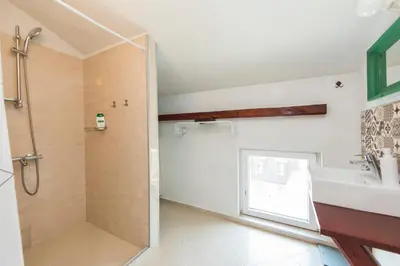a bathroom with a shower and a sink at Cozy family loft at Women's market in Sofia