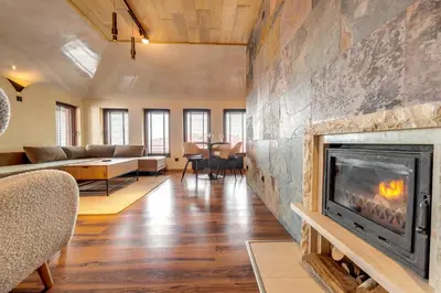 a living room with a fireplace and a couch at Luxury 1BD Retreat in Grand Resort Pamporovo by Flat Manаger in Pamporovo