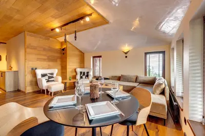 a living room with a table and a couch at Luxury 1BD Retreat in Grand Resort Pamporovo by Flat Manаger in Pamporovo