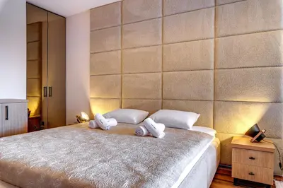 a bedroom with a large bed with towels on it at Luxury 1BD Retreat in Grand Resort Pamporovo by Flat Manаger in Pamporovo