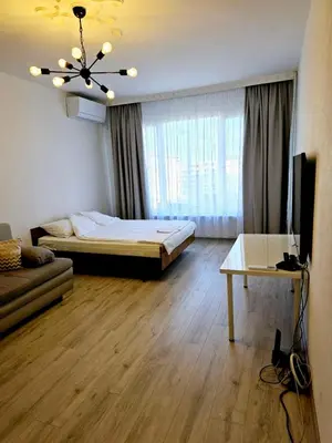 a bedroom with a bed and a television and a table at Ortakchiev 3 in Sofia