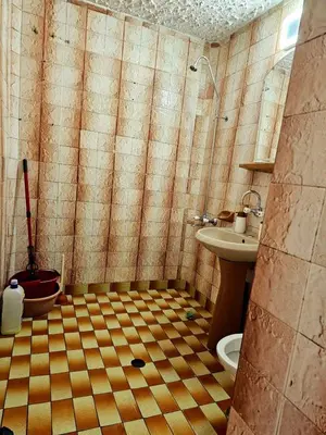 a tiled bathroom with a shower and a sink at Ortakchiev 3 in Sofia
