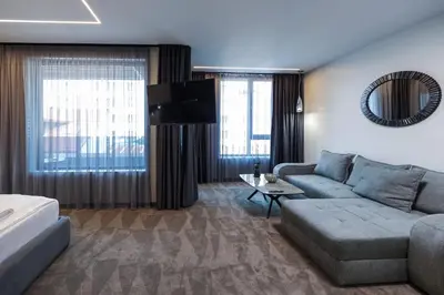 a living room with a couch and a tv at Home Lux in Gotse Delchev
