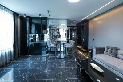 a lobby with a bar with stools and a couch at Home Lux in Gotse Delchev