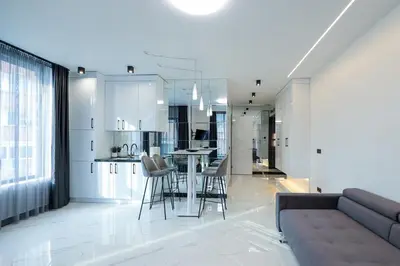 a living room and kitchen with a couch and a table at Home Lux in Gotse Delchev