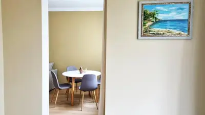 a dining room with a table and chairs and a picture at No X - Sofia top center in Sofia