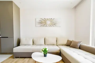 a living room with a couch and a table at Modern 1BD Near Paradise Center & Vitosha Metro by Flat Manager in Sofia
