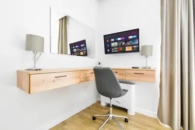 a desk with a monitor and a chair in a room at Modern 1BD Near Paradise Center & Vitosha Metro by Flat Manager in Sofia