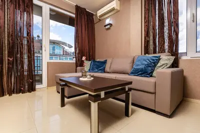 a living room with a couch and a table at Modern 2BD - 14 min to Medical University by Flat Manager in Plovdiv