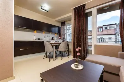 a living room with a kitchen and a dining room at Modern 2BD - 14 min to Medical University by Flat Manager in Plovdiv