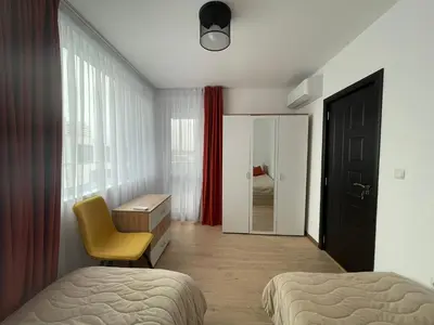 a bedroom with two beds and a desk and a chair at Sofia City Quiet Retreat in Sofia