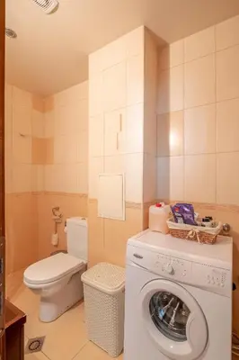 a bathroom with a washing machine and a toilet at Modern Apartment - Top Location - Friendly Host by Flat Manager in Sofia