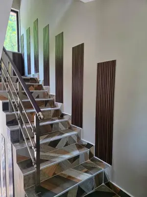 a staircase with wooden treads in a house at Хотел Ресторант Ваката in Teteven