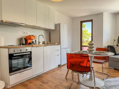 a kitchen and dining room with a table and chairs at 1BR Apartment with a Designated Workspace, Free Street Parking and Free Gym Pass in Plovdiv