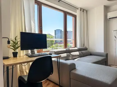 a living room with a computer desk and a couch at 1BR Apartment with a Designated Workspace, Free Street Parking and Free Gym Pass in Plovdiv