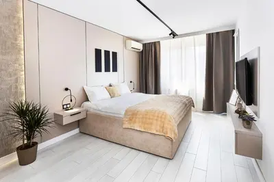 a bedroom with a bed and a flat screen tv at D-home in Sofia