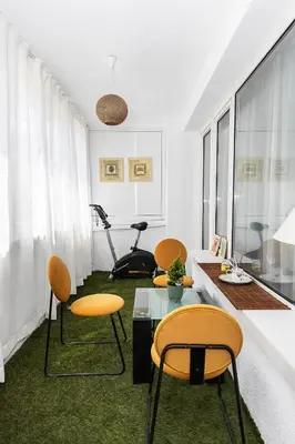 a living room with chairs and a table and a treadmill at D-home in Sofia