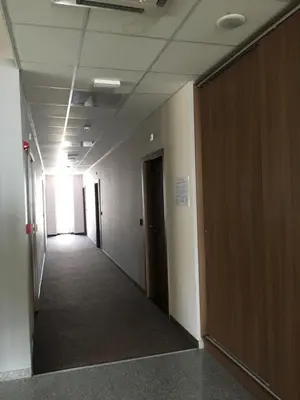 an empty hallway in an office building with a hallway at Hotel Iris in Plovdiv
