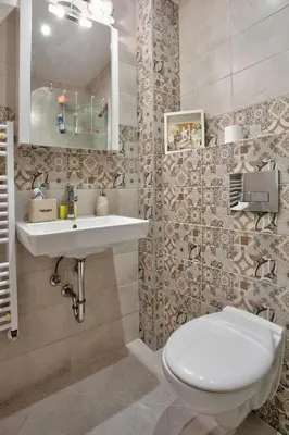 a bathroom with a toilet and a sink and a mirror at City Nest 1BD in Lozenets by Flat Mаnager in Sofia