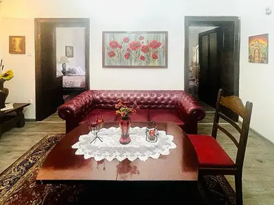 a living room with a leather couch and a table at Retro Gem in Sofia
