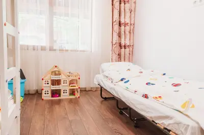 a bedroom with a bed and a toy house at Pavlina Guest House in Tsŭrvishte