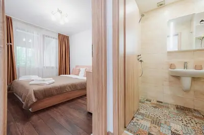 a bedroom with a bed and a sink and a mirror at Pavlina Guest House in Tsŭrvishte