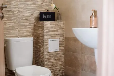 a bathroom with a toilet and a sink at Pavlina Guest House in Tsŭrvishte
