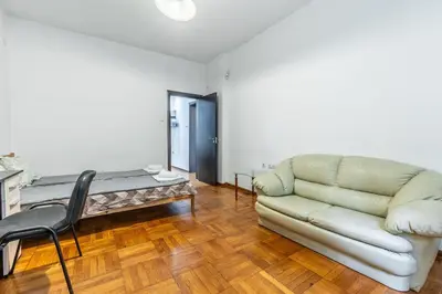 a living room with a couch and a table at Sofique 3BR in Sofia