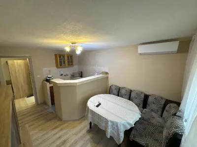 a room with a couch and a table in it at DJOKI Apartment in Sandanski