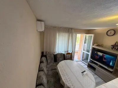 a living room with a couch and a tv at DJOKI Apartment in Sandanski
