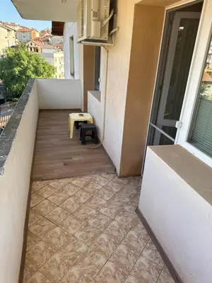 a small balcony with a bench on a building at DJOKI Apartment in Sandanski