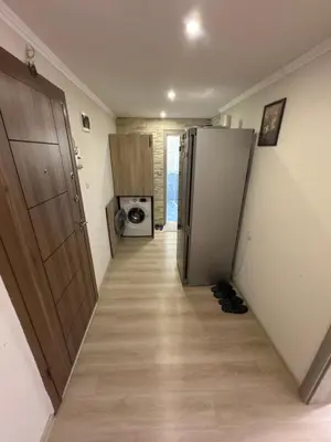 a hallway with a refrigerator and a microwave at DJOKI Apartment in Sandanski