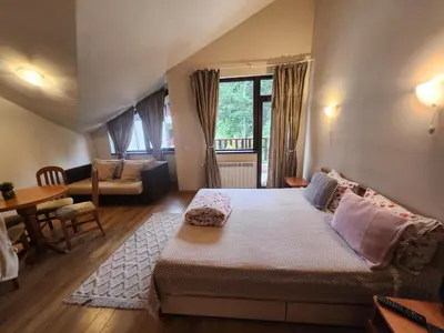 a bedroom with a bed and a living room at Borovets Violet by Ski slopes in Borovets