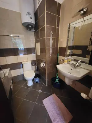 a bathroom with a toilet and a sink at Borovets Violet by Ski slopes in Borovets