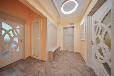 a hallway with orange walls and wooden floors and a door at Oranssi Sunset - Free Parking in Sofia