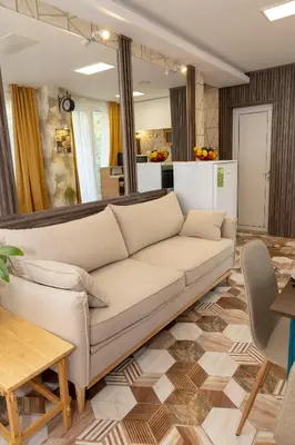 a living room with a couch and a table at Good Mood Apartments & Parking in Plovdiv