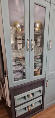 a blue cabinet with plates and dishes in it at Boutique Apartment Katerina in Bansko