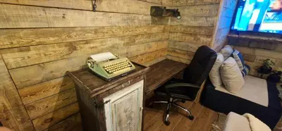 a room with a desk with a typewriter and a chair at Boutique Apartment Katerina in Bansko