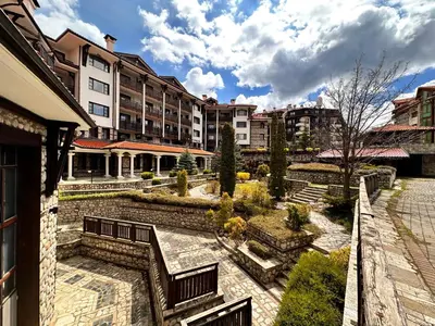 a view of a courtyard with benches and buildings at Beby's Apartment - Tamplier in Bansko