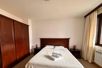 a bedroom with a bed with two towels on it at Beby's Apartment - Tamplier in Bansko