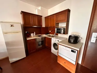 a kitchen with a white refrigerator and a dishwasher at Beby's Apartment - Tamplier in Bansko