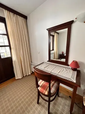 a room with a mirror and a table with a chair at Beby's Apartment - Tamplier in Bansko