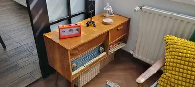 a wooden cabinet with an alarm clock on top of it at Appartement vintage près de l'Académie de Medecine in Sofia