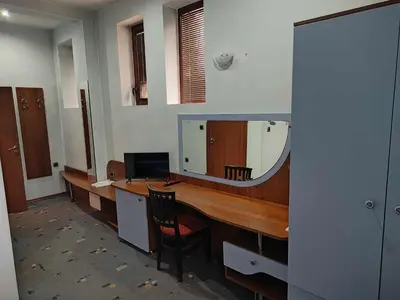an office with a desk with a mirror at Семеен хотел МАКСИМ in Teteven