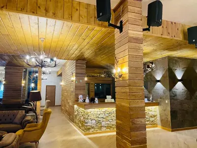 a living room with a stone wall at Studio Harmony, Pamporovo in Pamporovo