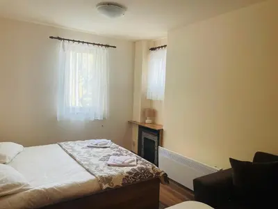 a small bedroom with a bed and a fireplace at Studio Harmony, Pamporovo in Pamporovo